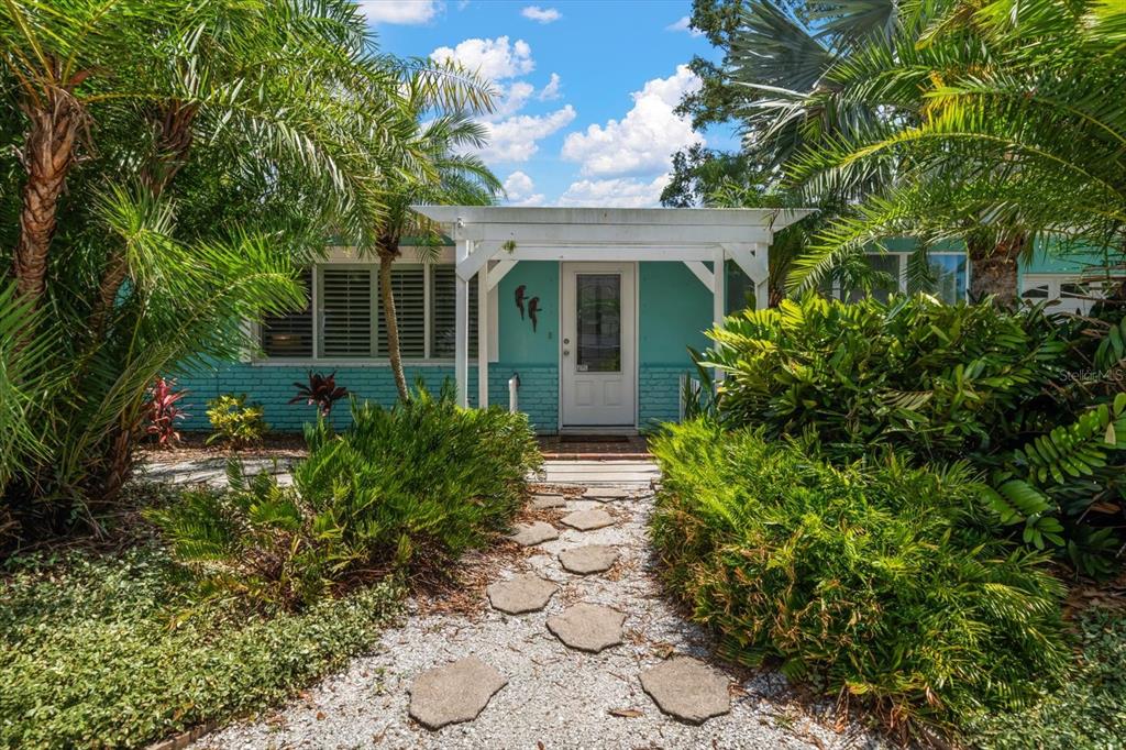 301 Cevera Road Dunedin, FL 34698 - Photo 1 of 33 front view of a house with a garden