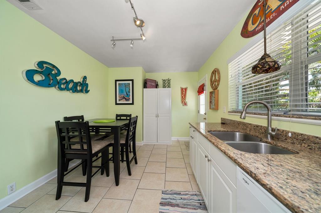 301 Cevera Road Dunedin, FL 34698 - Photo 11 of 33 a kitchen with granite countertop a sink and a refrigerator