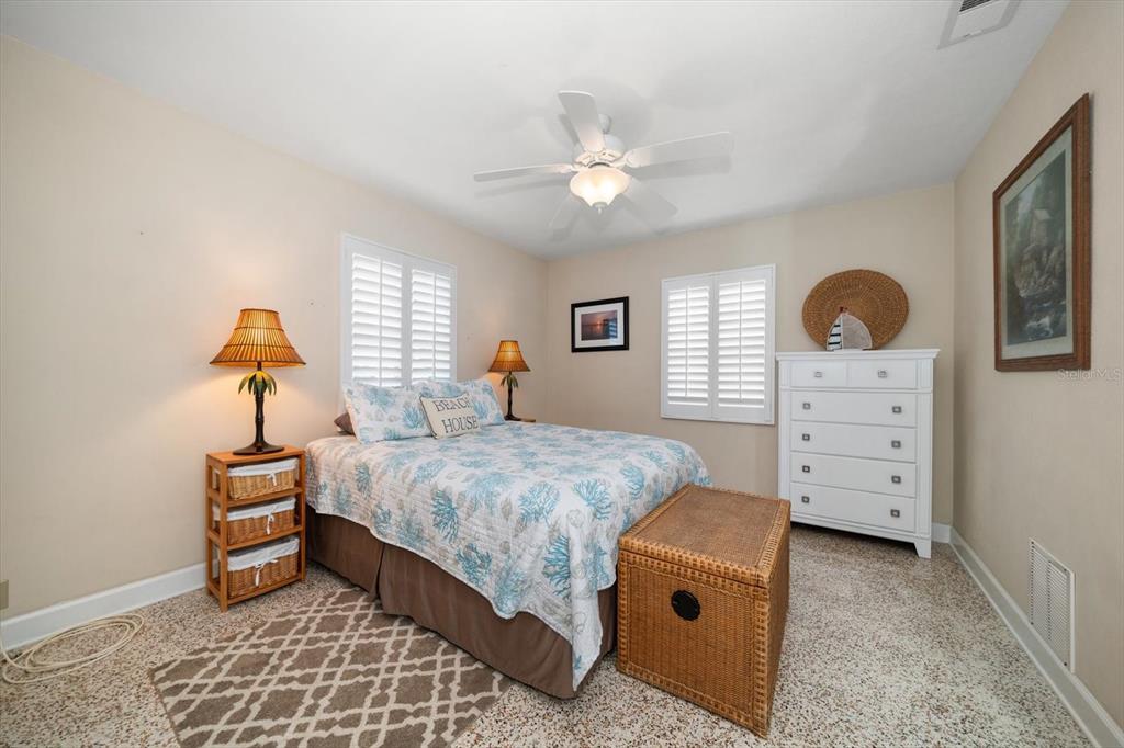 301 Cevera Road Dunedin, FL 34698 - Photo 14 of 33 a bedroom with a bed and a chandelier