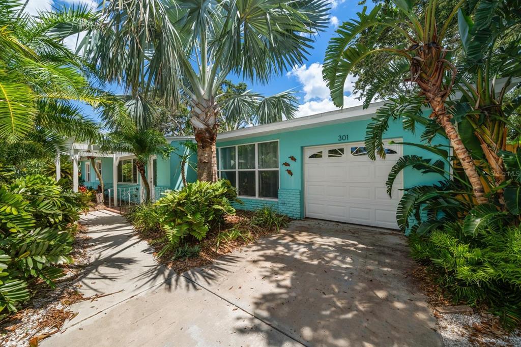 301 Cevera Road Dunedin, FL 34698 - Photo 2 of 33 front view of a house with a garden