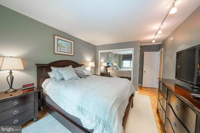 a bedroom with bed tv and window