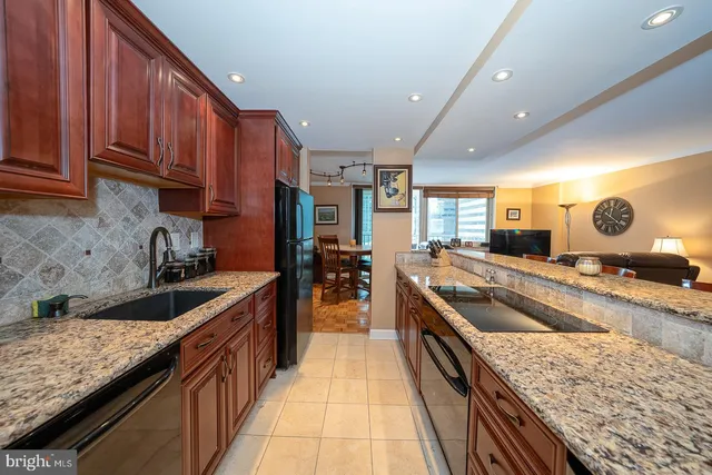 a large kitchen with stainless steel appliances granite countertop a lot of counter space