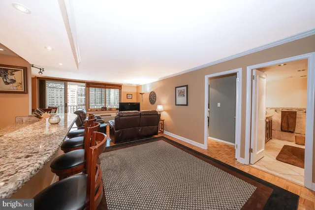 a living room with furniture a large window and flat screen tv