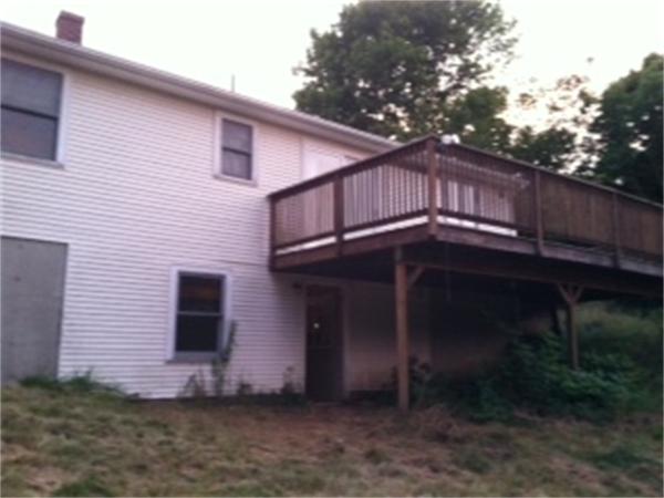 68 Wood Hill Road Monson, MA 01057 - Photo 2 of 3 a front view of a house with a yard