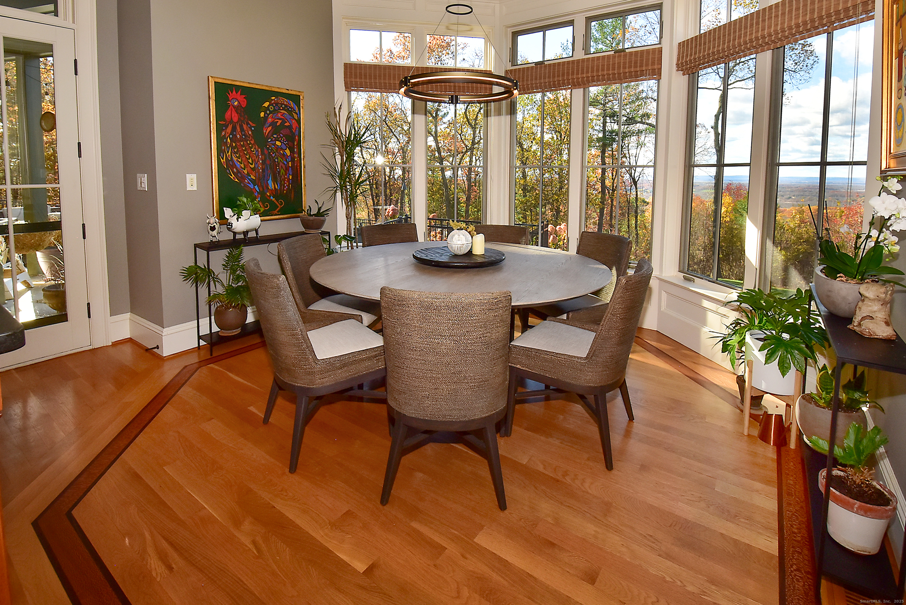 a dining room with furniture window and wooden floor