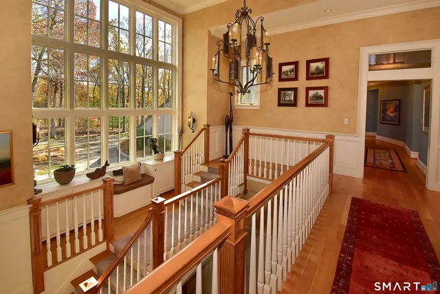a view of entryway and hall with wooden floor