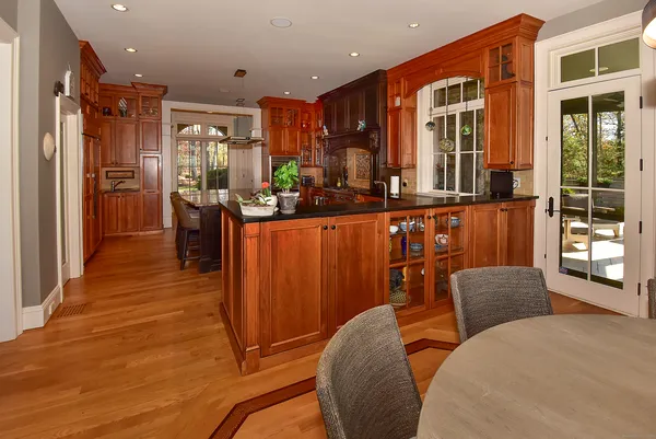 a living room with furniture a large window and stainless steel appliances