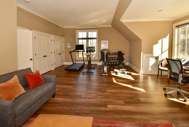 a living room with furniture and a table with wooden floor