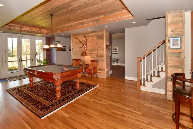 a living room with furniture stove and wooden floor