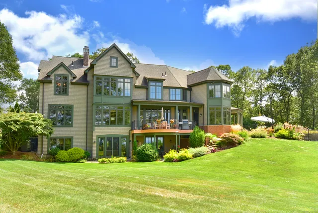 a front view of a house with a yard table and chairs