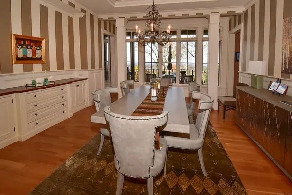 a living room with furniture a window and a chandelier