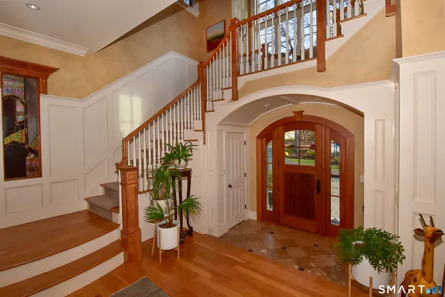a view of entryway with a front door and wooden floor
