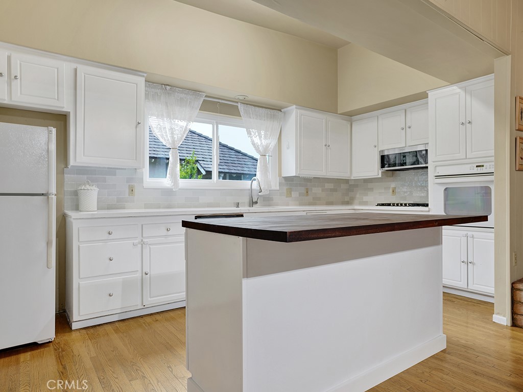 1019 Dorothy Lane Fullerton, CA 92831 - Photo 18 of 41 a kitchen with granite countertop white cabinets and white appliances