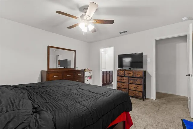 a bedroom with a bed and a television