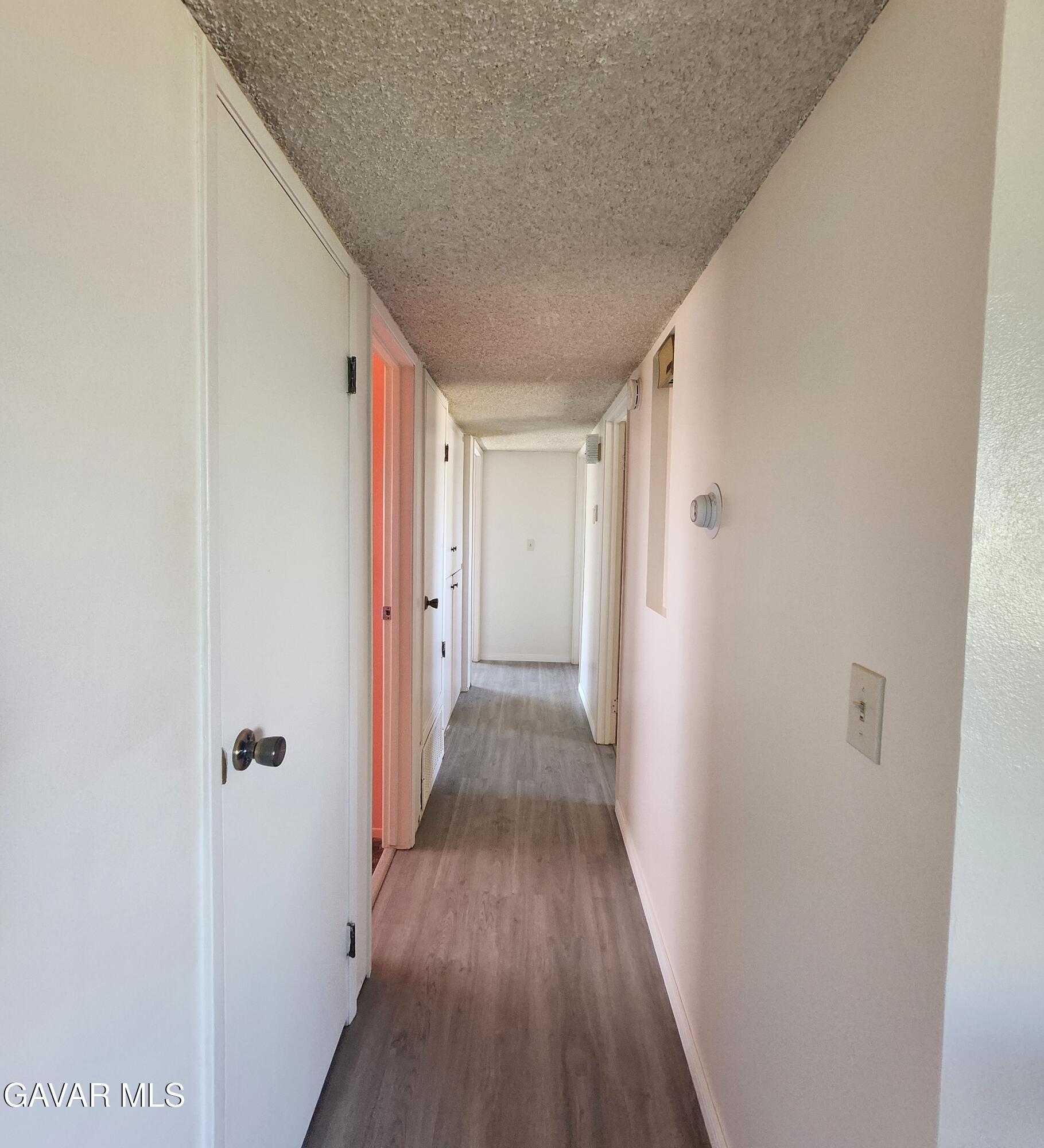 1407 West Burns Avenue Ridgecrest, CA 93555 - Photo 13 of 25 a view of a hallway with wooden floor