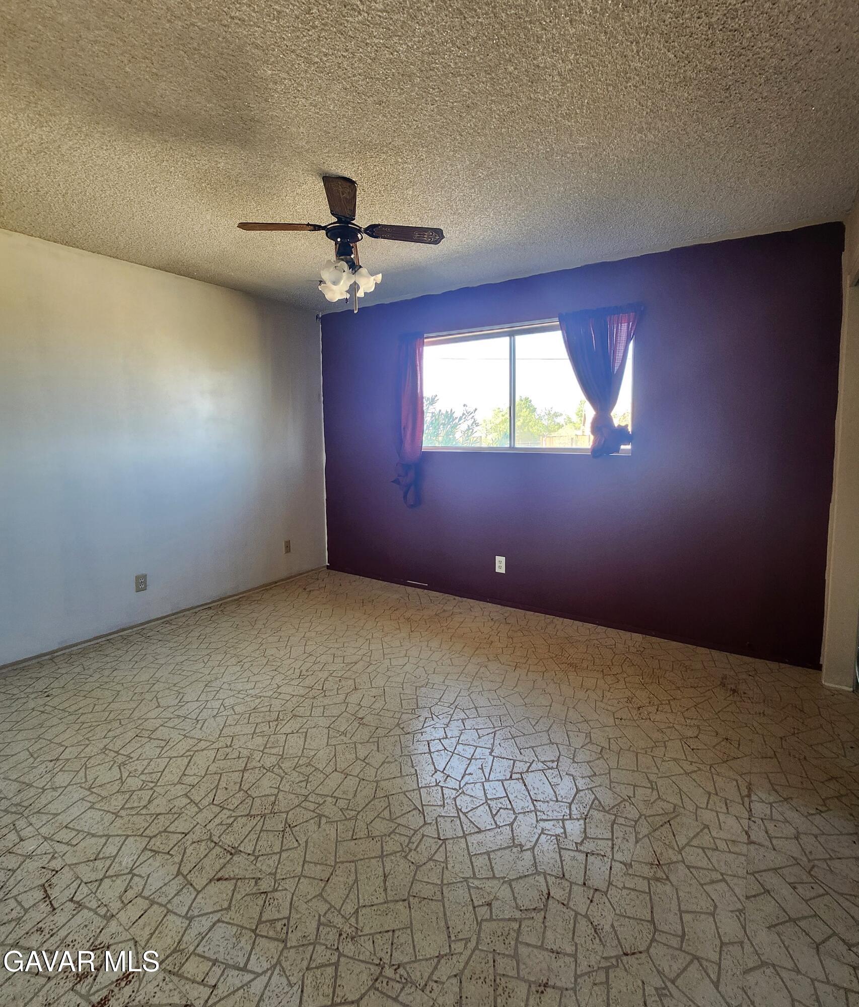 1407 West Burns Avenue Ridgecrest, CA 93555 - Photo 19 of 25 an empty room with windows and fan