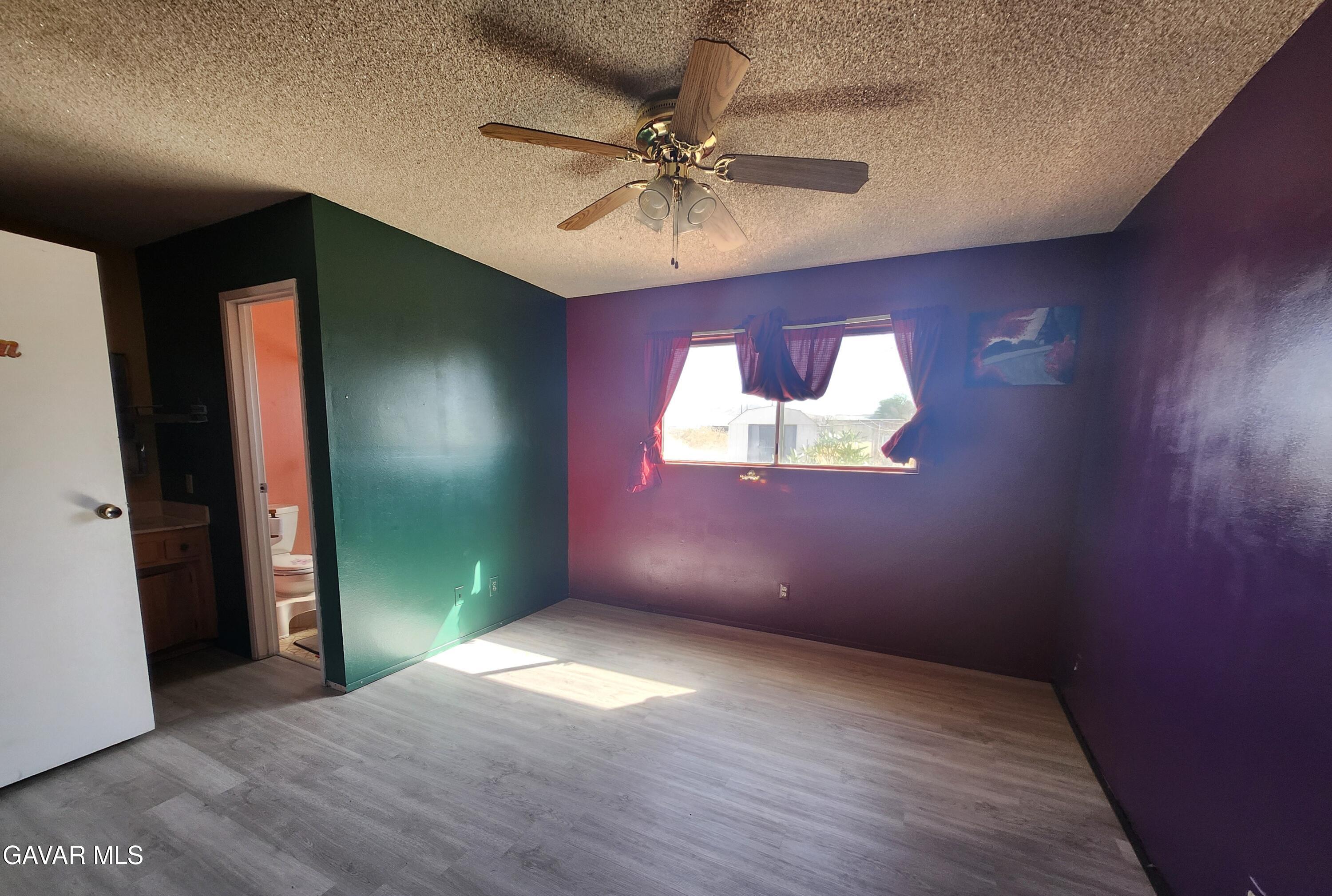 1407 West Burns Avenue Ridgecrest, CA 93555 - Photo 21 of 25 wooden floor in an empty room with a window