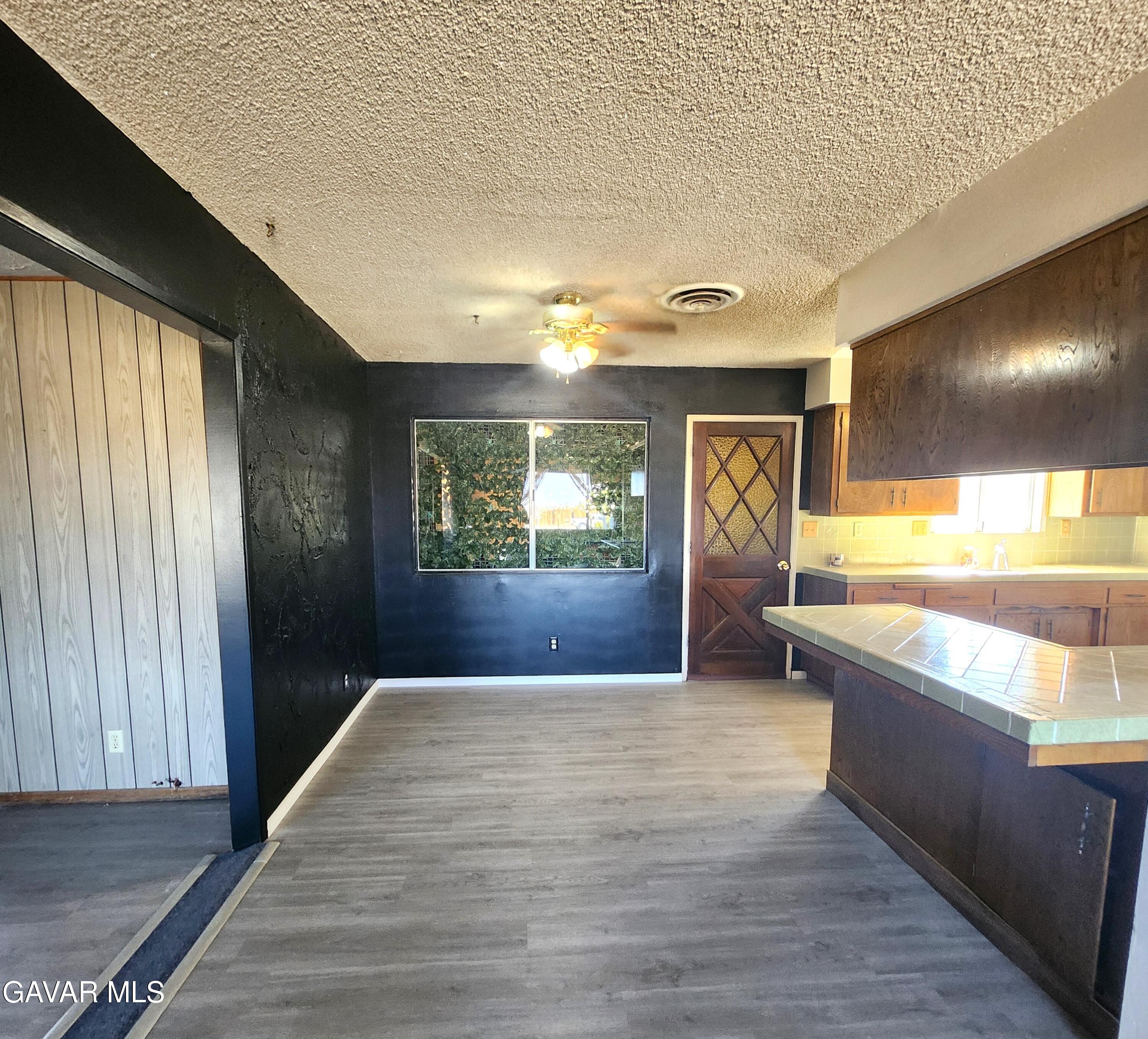 1407 West Burns Avenue Ridgecrest, CA 93555 - Photo 6 of 25 a view of a hallway with wooden floor and a large window