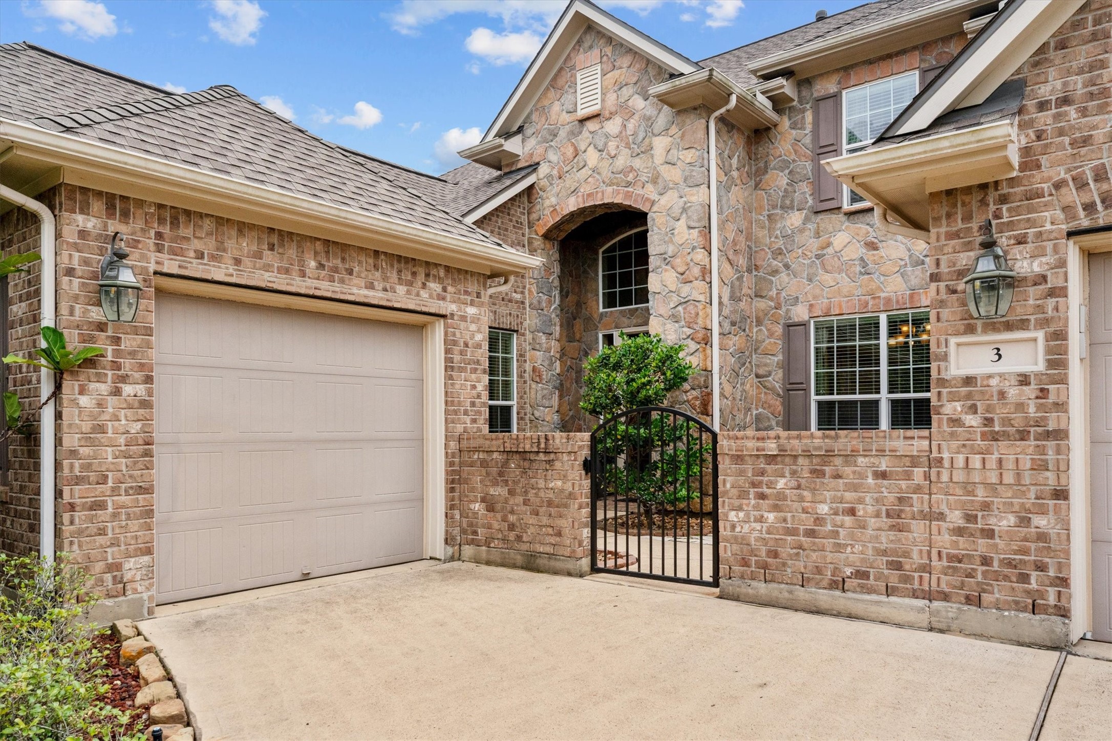 3 Indigo Bunting Place Spring, TX 77389 - Photo 7 of 41 A wrought iron gate leads to a private courtyard, adding charm and curb appeal.