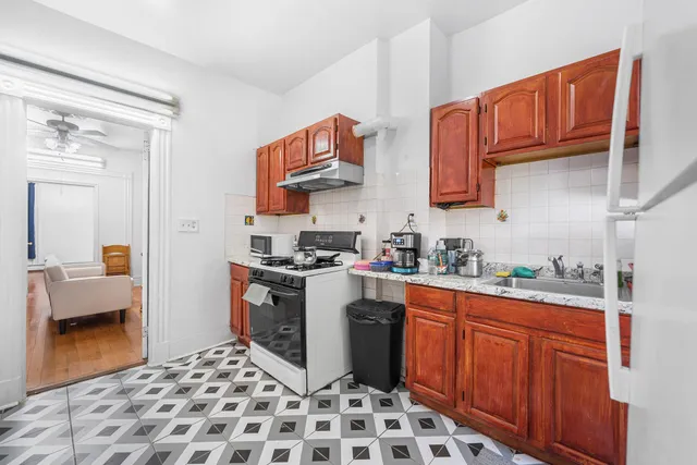 a kitchen with stainless steel appliances a sink stove top oven and cabinets