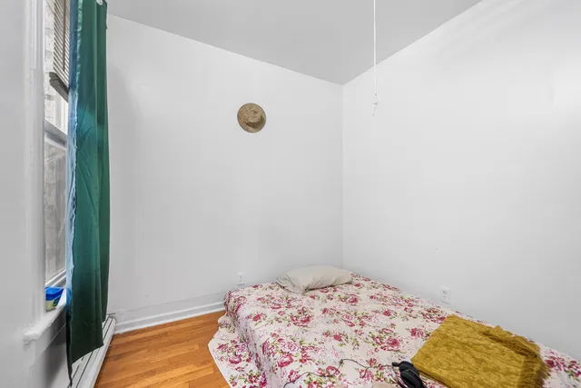 a bedroom with a bed and a rug