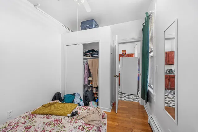 a bedroom with a bed and a dresser