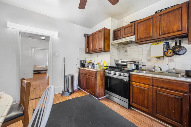 a kitchen with stainless steel appliances granite countertop wooden cabinets a stove top oven a sink and dishwasher
