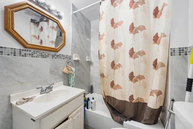 a bathroom with a sink and mirror with toilet