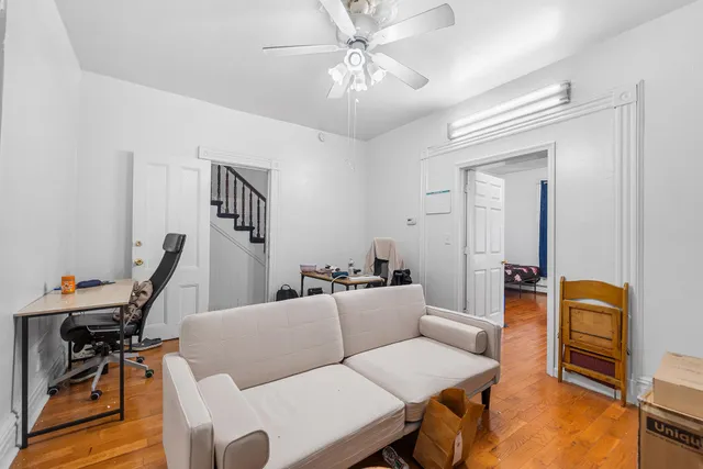 a living room with furniture a piano and a flat screen tv