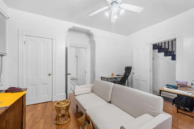 a living room with furniture and a chandelier