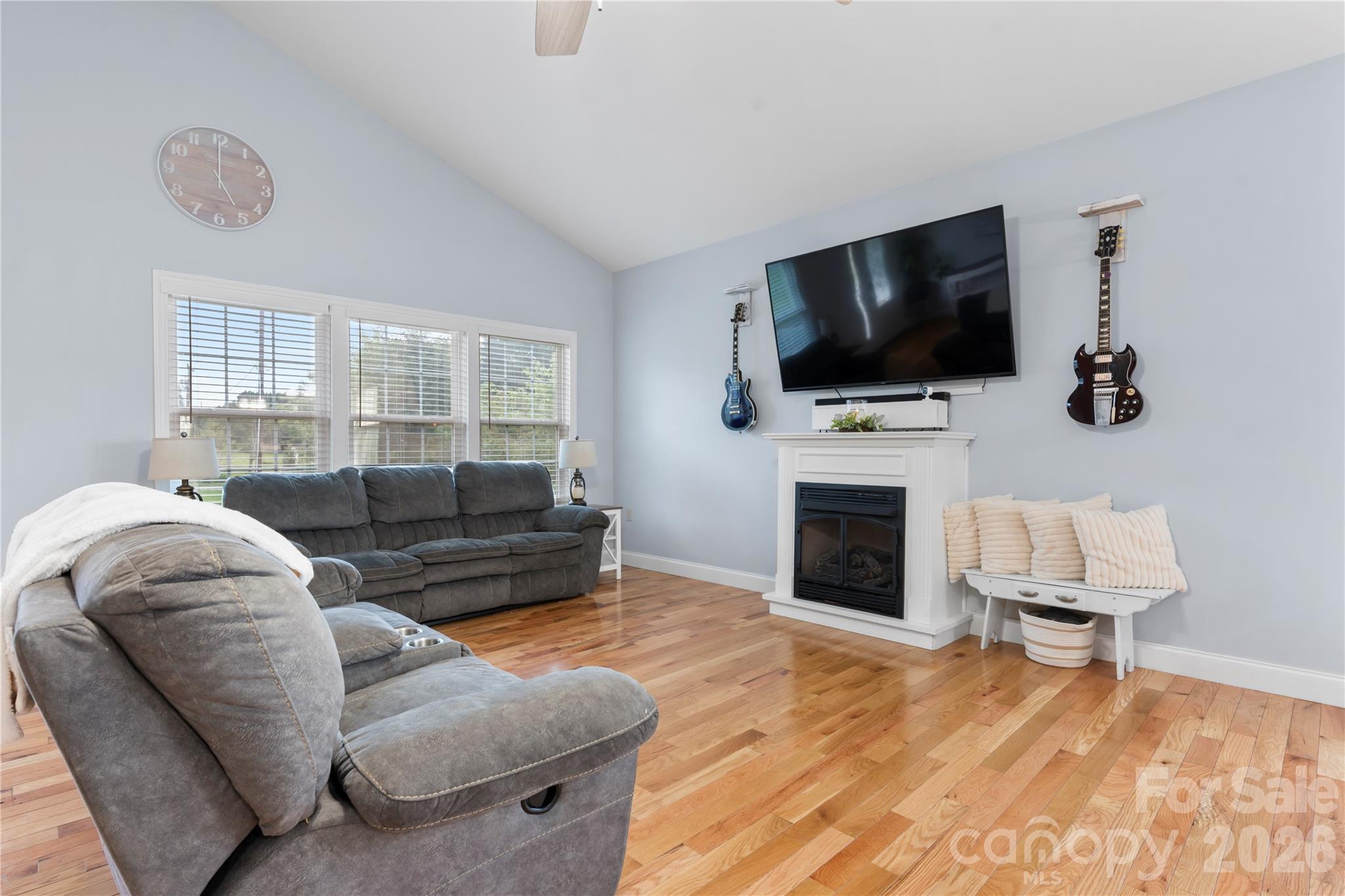 111 Pinewood Road Granite Falls, NC 28630 - Photo 7 of 33 a living room with furniture a flat screen tv and a fireplace