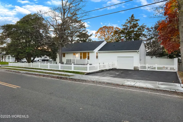a view of street along with house and trees