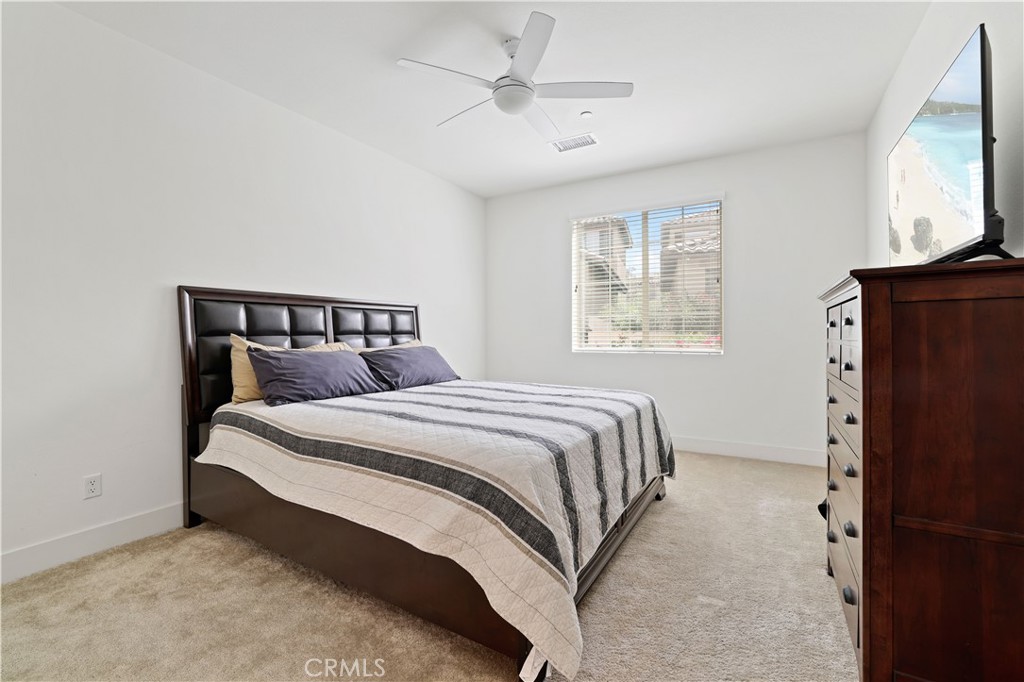 80138 Whisper Rock Way La Quinta, CA 92253 - Photo 14 of 29 a bedroom with a bed and a window