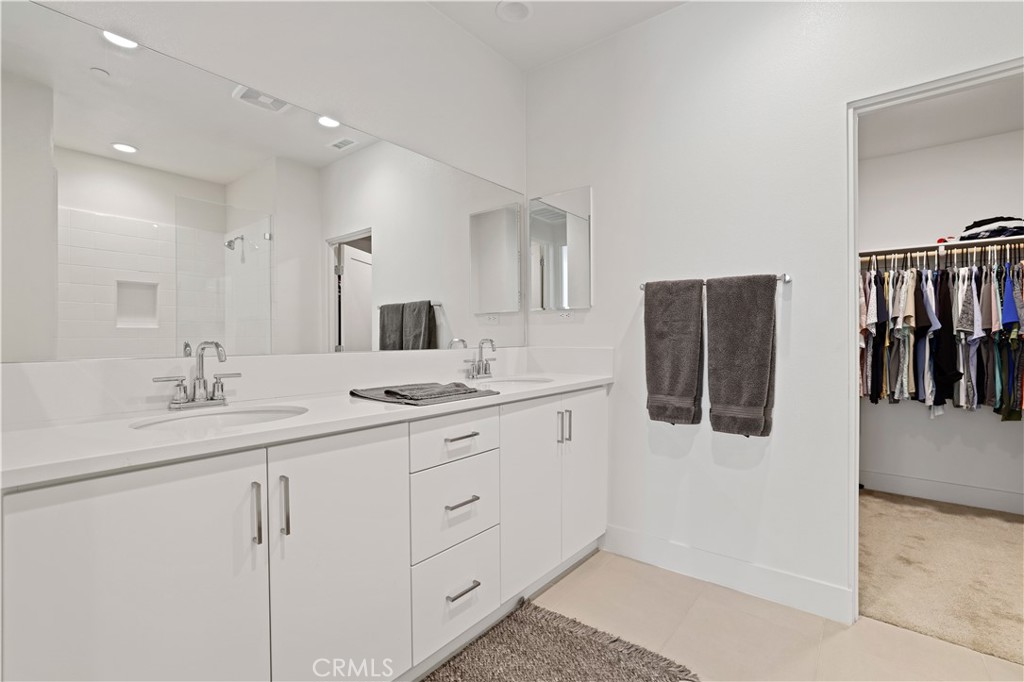 80138 Whisper Rock Way La Quinta, CA 92253 - Photo 16 of 29 a bathroom with double sink and a mirror