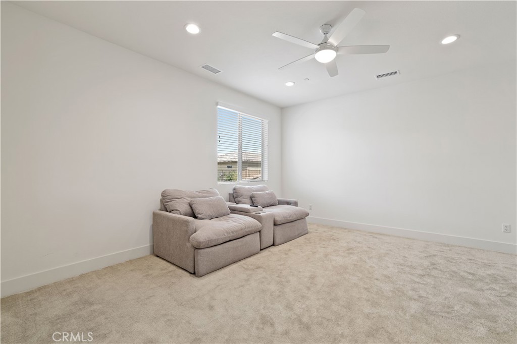 80138 Whisper Rock Way La Quinta, CA 92253 - Photo 19 of 29 an empty room with windows and ceiling fan