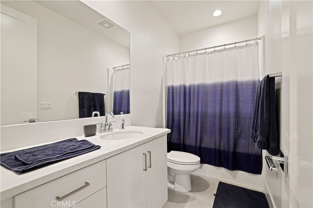 80138 Whisper Rock Way La Quinta, CA 92253 - Photo 24 of 29 a bathroom with a toilet a sink and a mirror