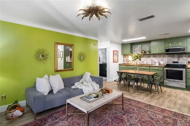 a living room with furniture and a wooden floor