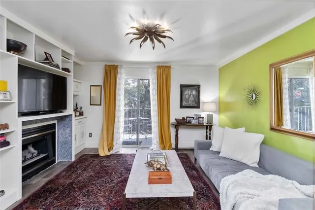 a living room with furniture a flat screen tv and a fireplace