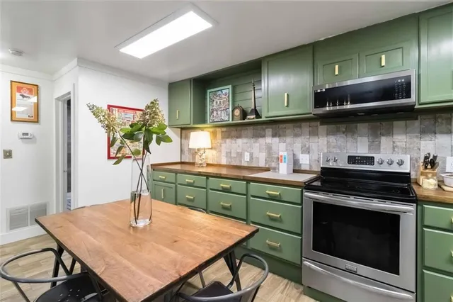 a kitchen with stainless steel appliances granite countertop a stove a sink dishwasher and cabinets