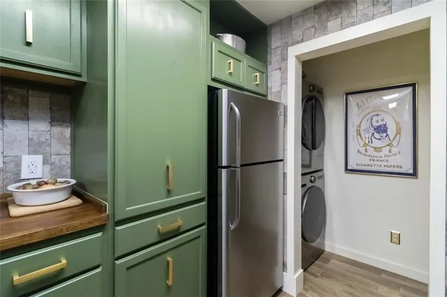 a kitchen with a refrigerator and cabinets