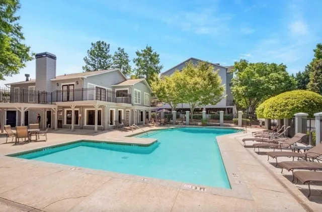a view of a house with a yard patio and fire pit