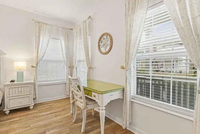 a view of a hallway with entryway wooden floor and front door