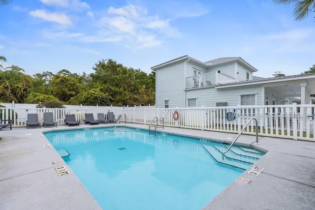 a view of a house with swimming pool and sitting area