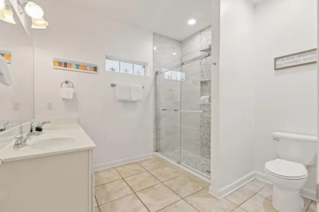 a bathroom with a toilet sink and shower