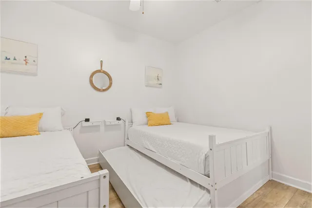 a bedroom with a bed and white cabinets