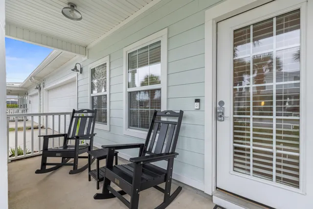 a view of a room with furniture and windows