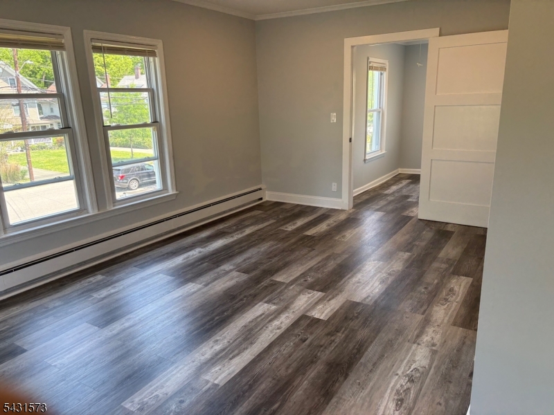 358 Woodland Road, Unit 2 Madison, NJ 07940 - Photo 14 of 50 an empty room with wooden floor and windows