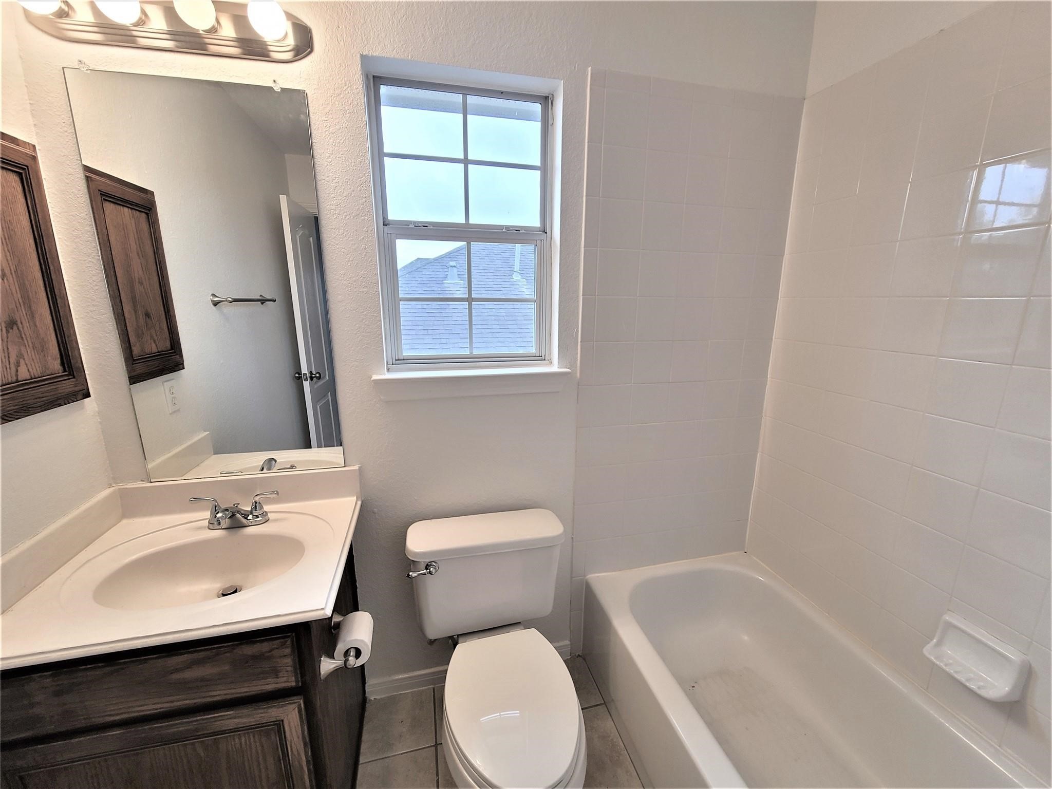 10026 Gil Jr Lane Houston, TX 77075 - Photo 13 of 14 a bathroom with a sink toilet and shower