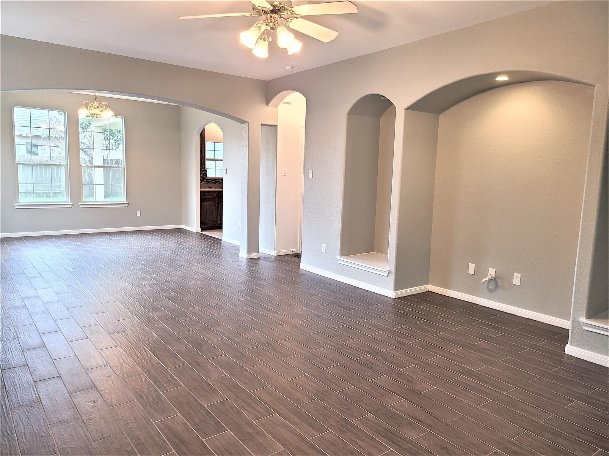 10026 Gil Jr Lane Houston, TX 77075 - Photo 2 of 14 an empty room with wooden floor and windows