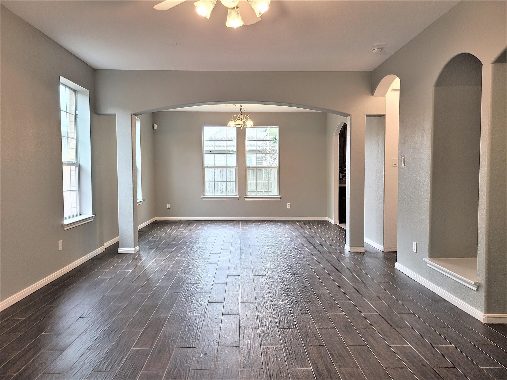 10026 Gil Jr Lane Houston, TX 77075 - Photo 3 of 14 an empty room with wooden floor and windows